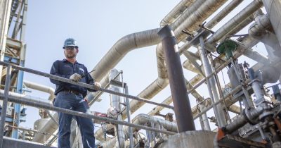 Man holding a radio on an Oil and Gas site