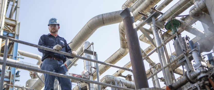 Man holding a radio on an Oil and Gas site